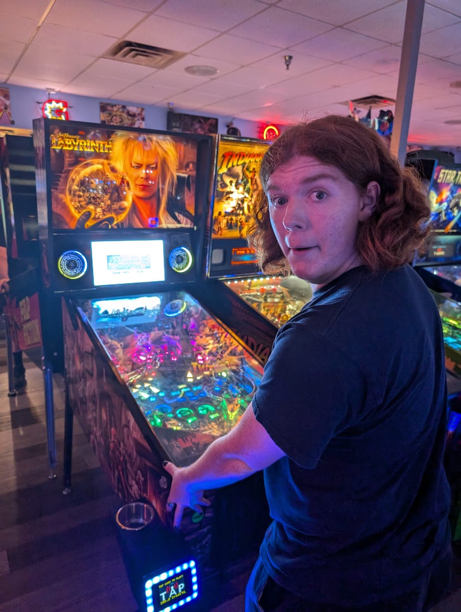 Liam Reid playing a pinball machine
